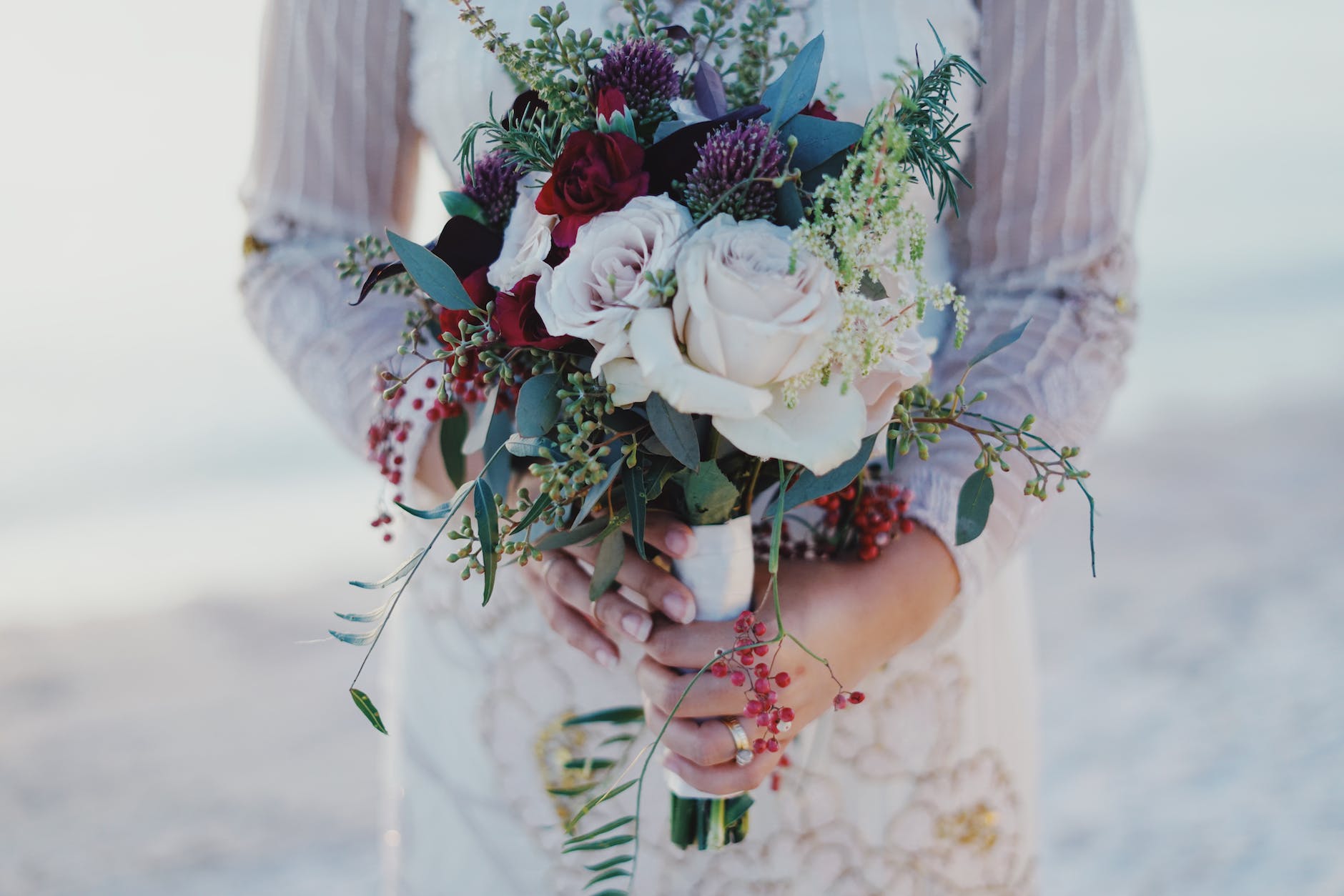 woman holding red and white rose bouquet