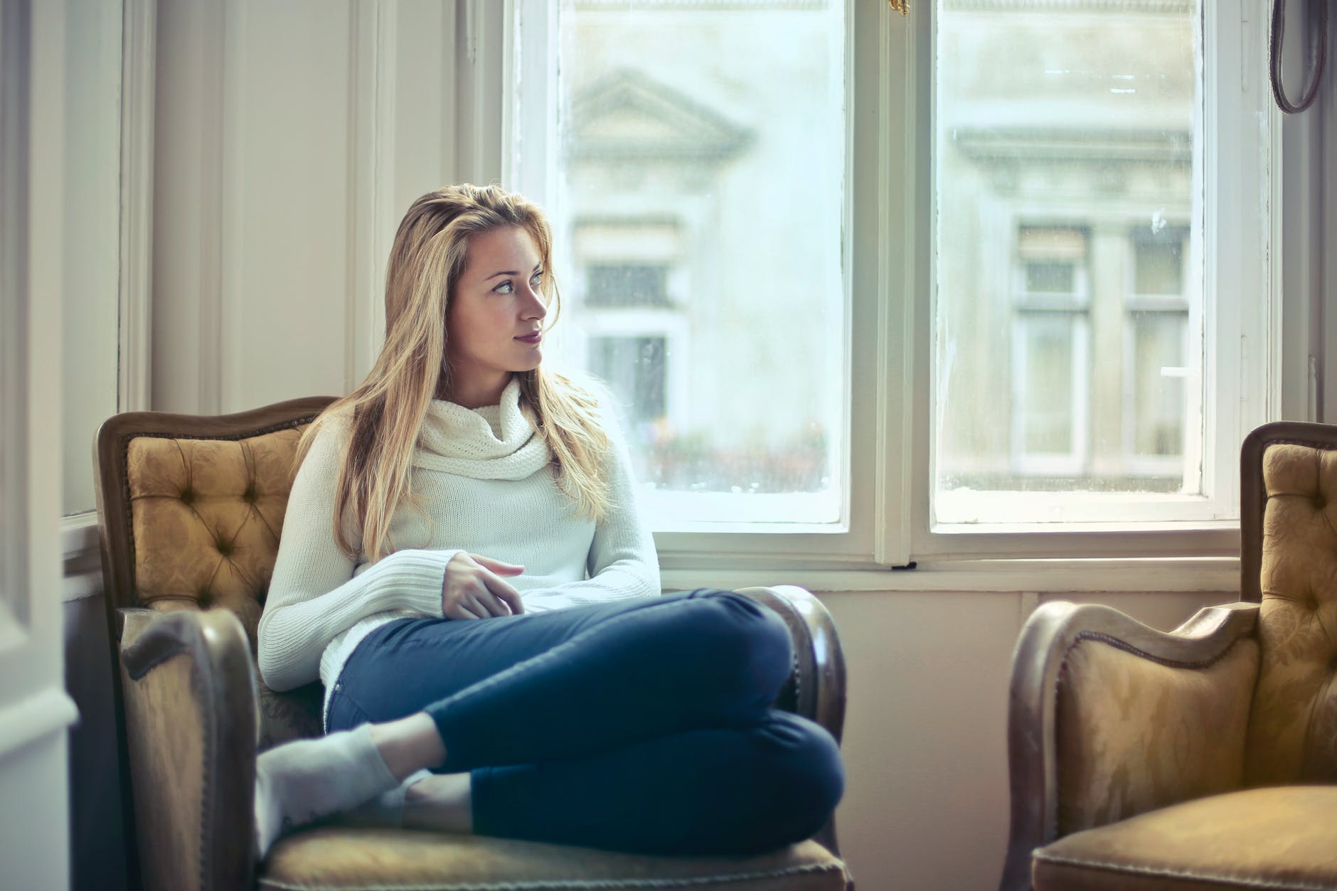 pexels-photo-761872 photography of woman sitting on chair near window