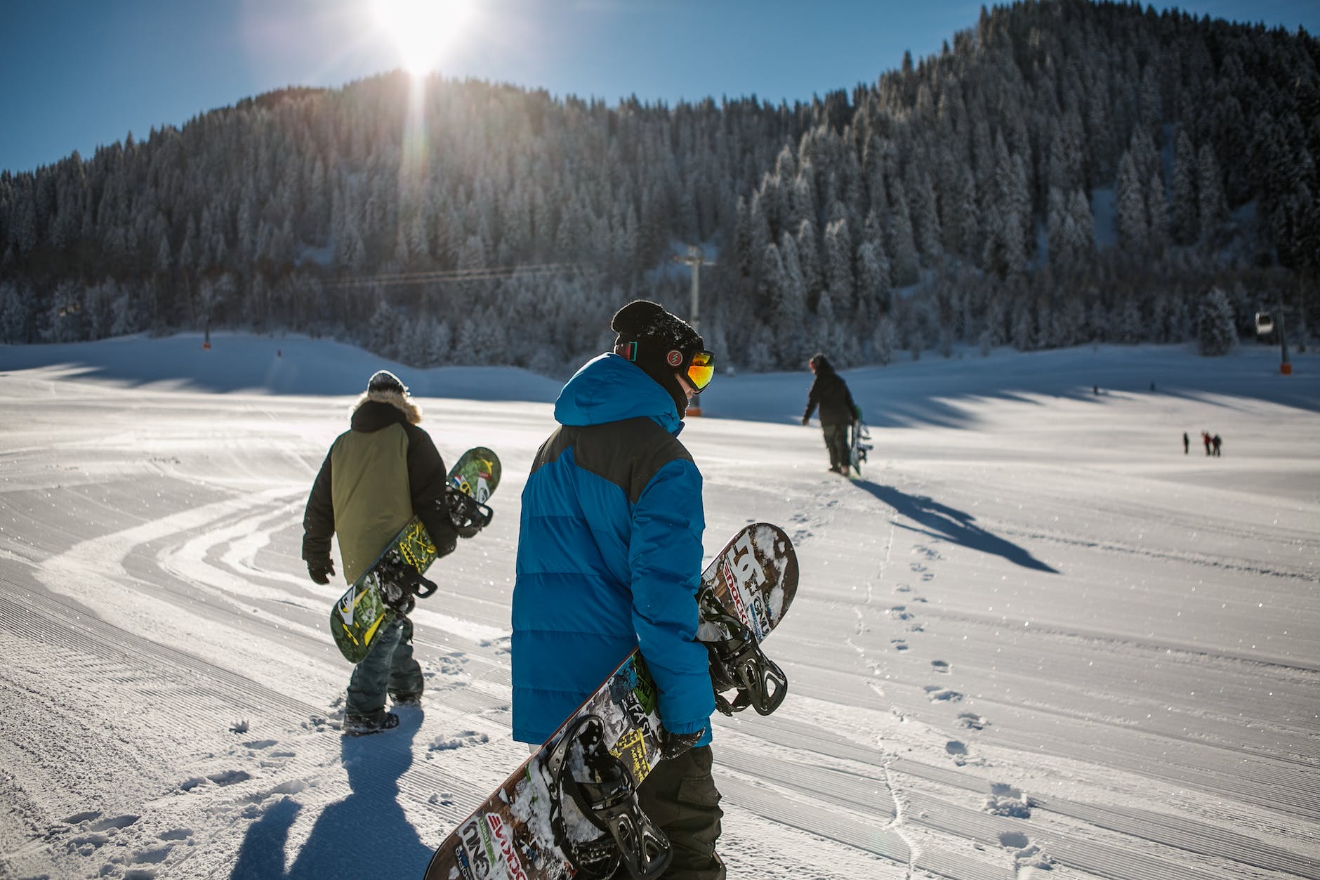 pexels-photo-848612 person wearing blue winter jacket carrying snowboard under sunny sky