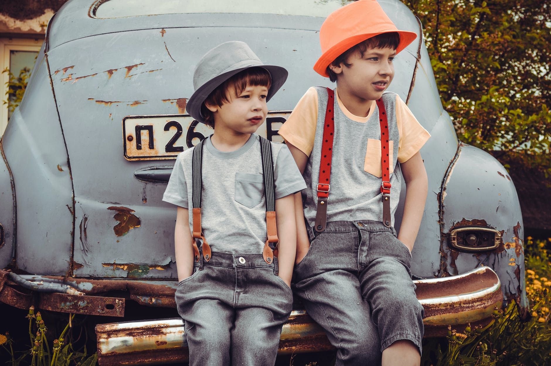 pexels-photo-1094084 two boys sitting on vehicle bumper