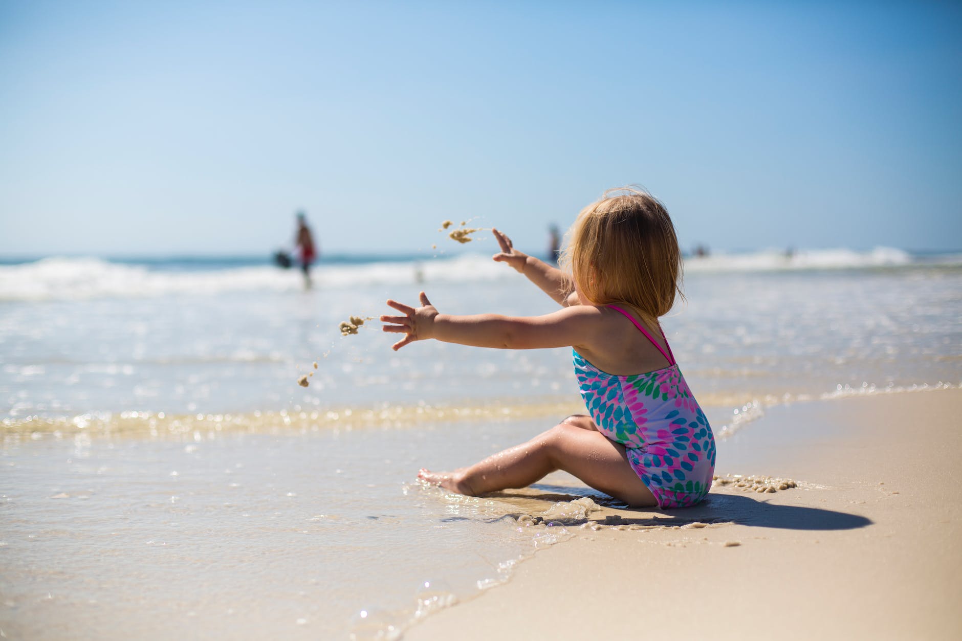 pexels-photo-1712855 toddler girl sitting on shore during day
