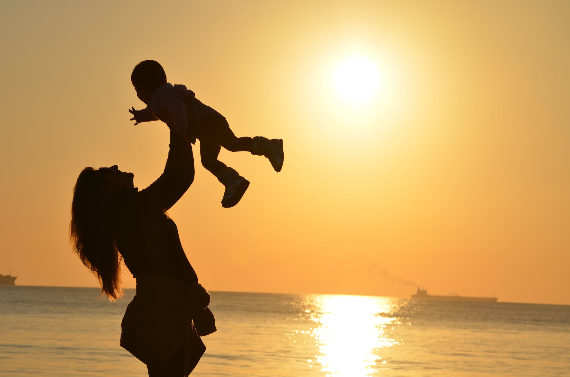 mother-daughter-love-sunset-51953 silhouette photo of a mother carrying her baby at beach during golden hour