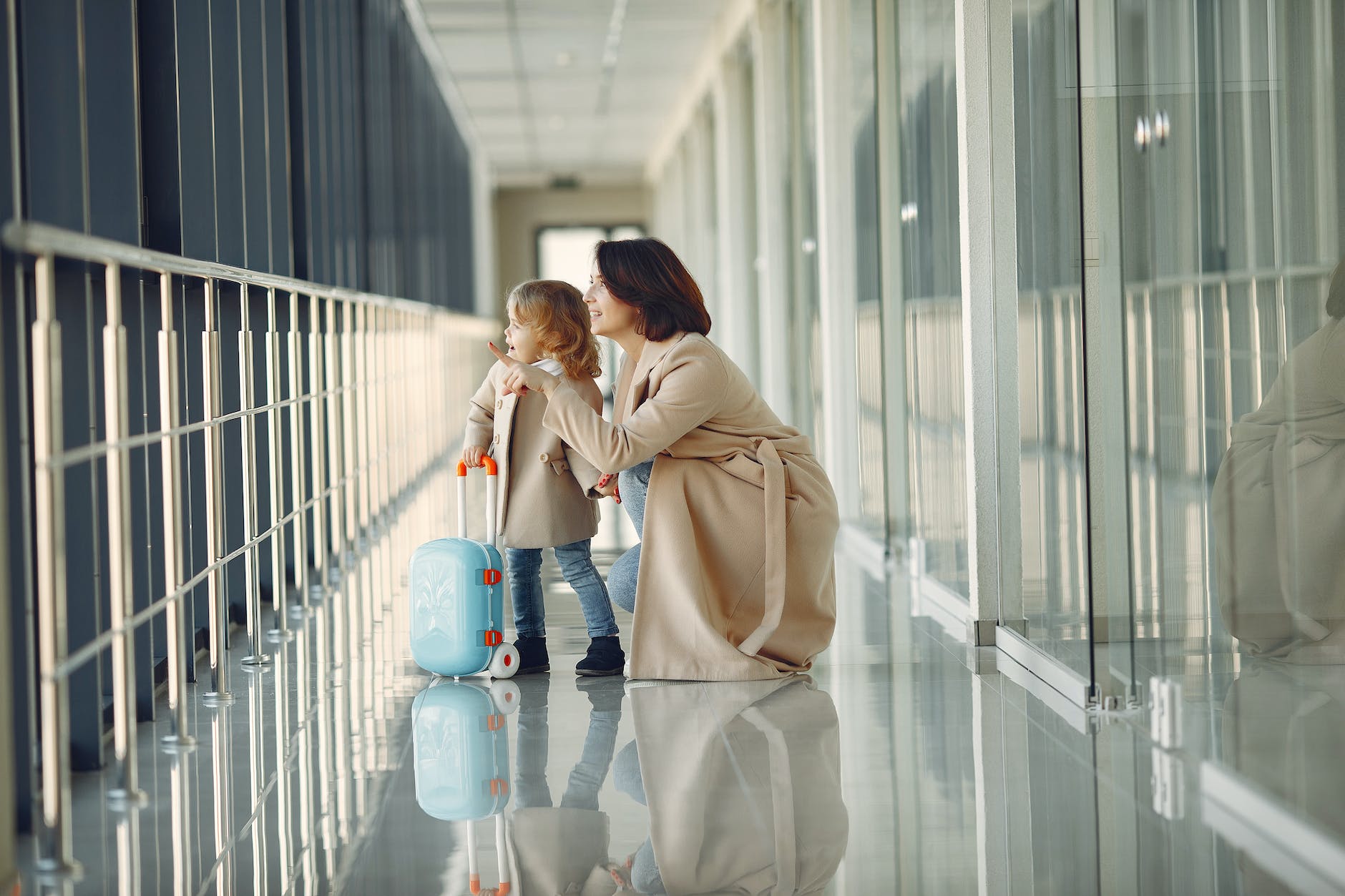 amazed daughter and mother in airport hallway