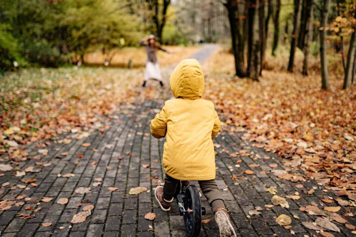 kid on bike leaves