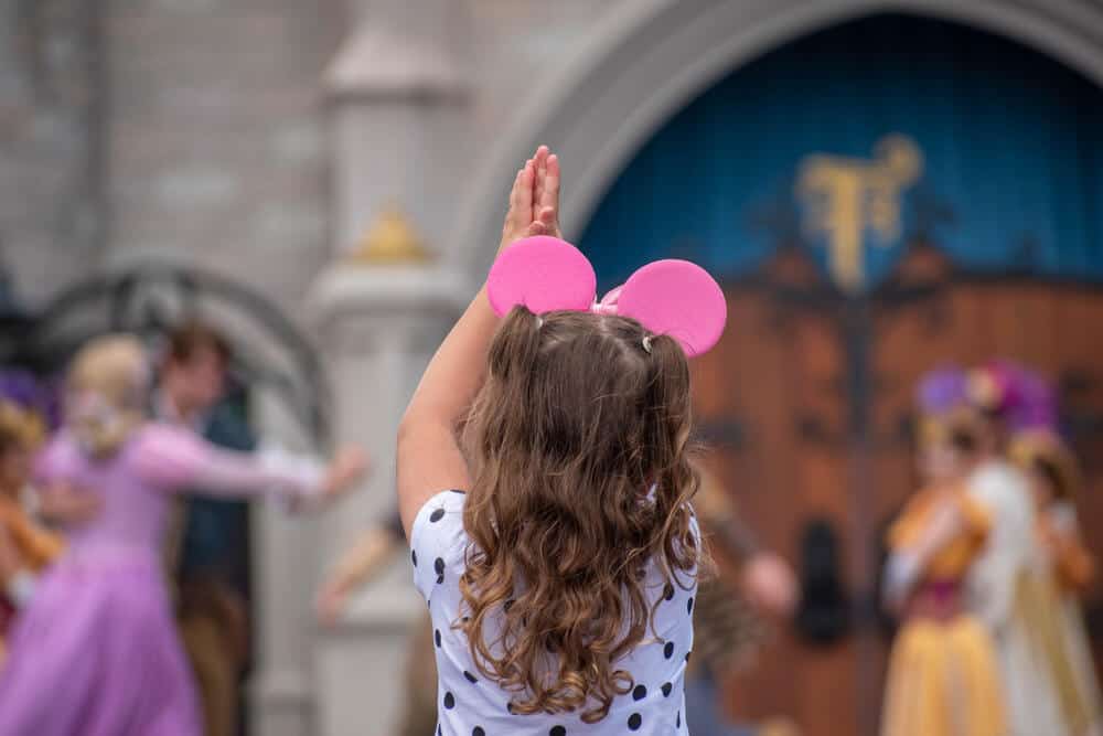 child wearing pink mickey mouse ears