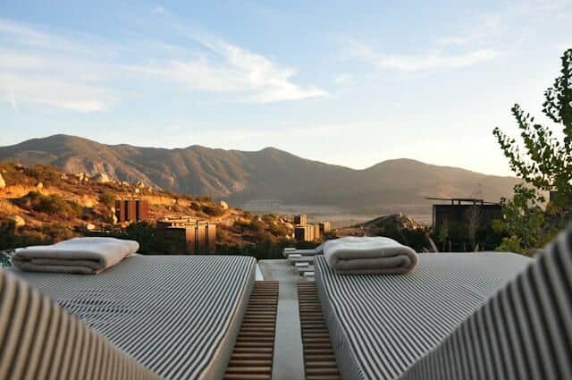 sun beds at luxury hotel with view of mountains 