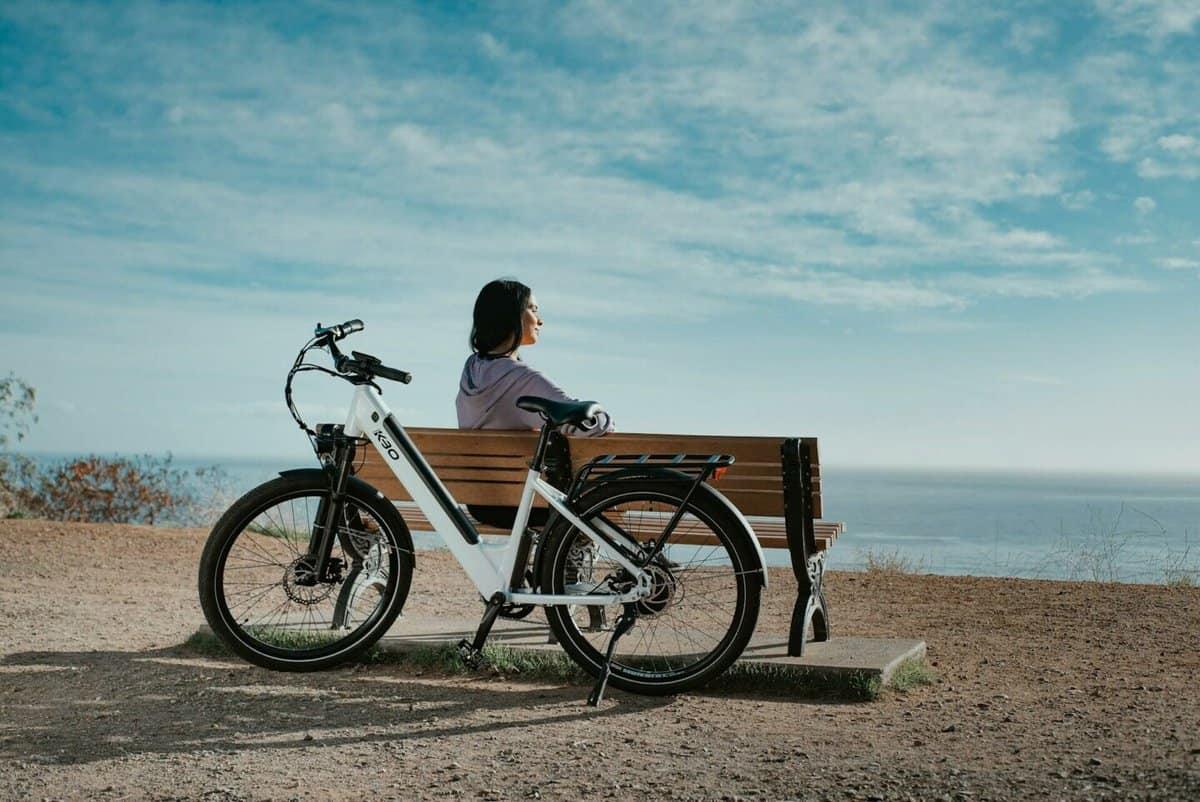 woman on bench with e bike
