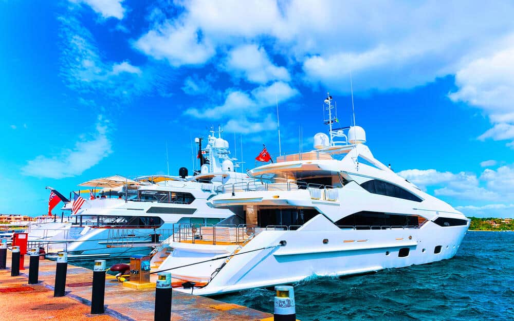 Scenery with Marina and luxury yachts at Mediterranean Sea of Porto Cervo in Sardinia Island of Italy in summer. Landscape View on Sardinian town port with ships and boats in Sardegna. 