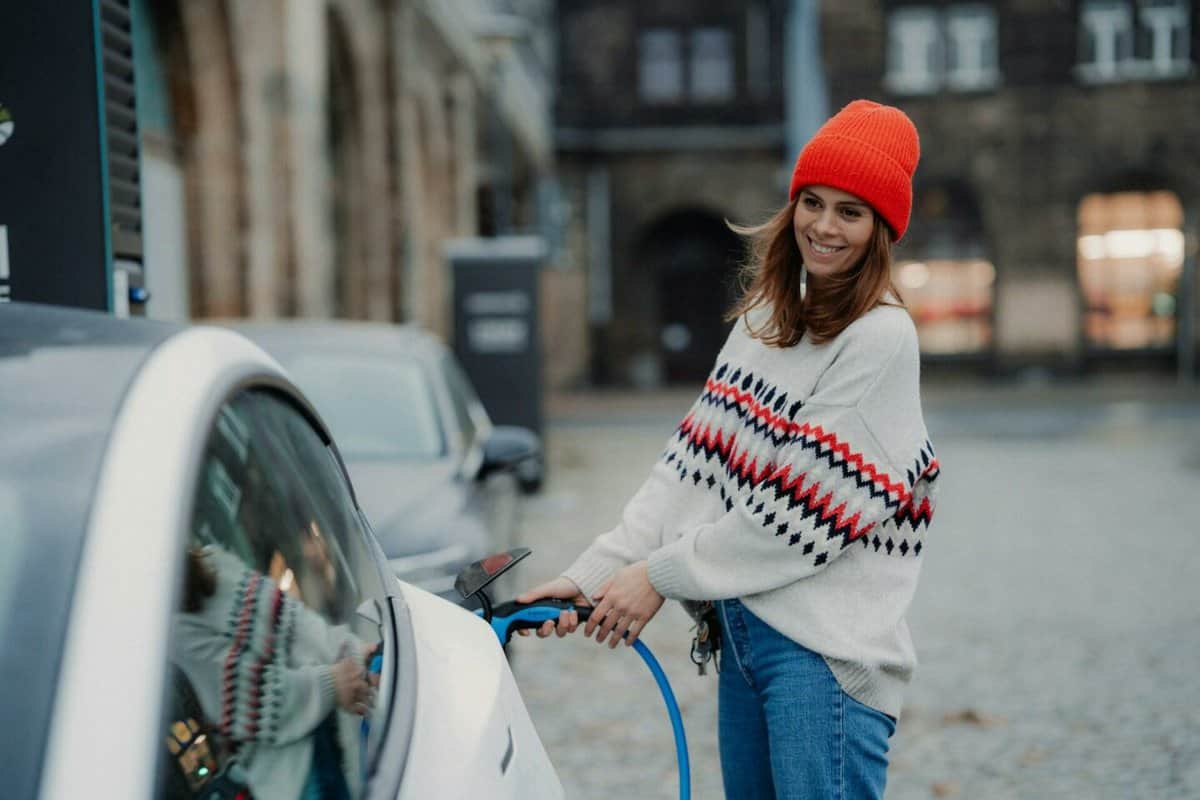 woman charging electric car