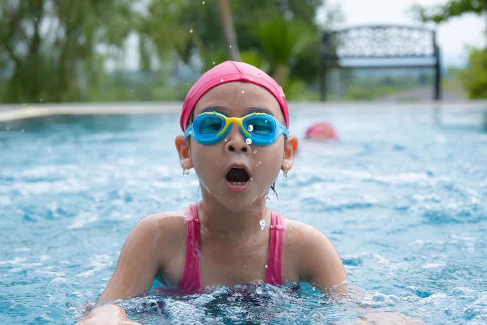 child swimming in pool