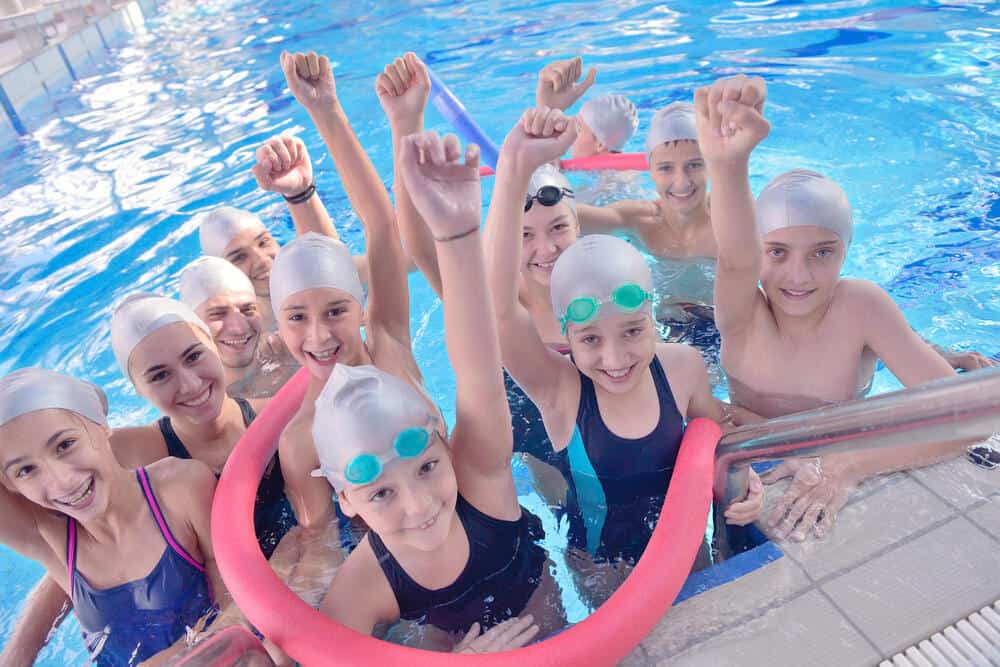 group of children in pool after swimming lesson