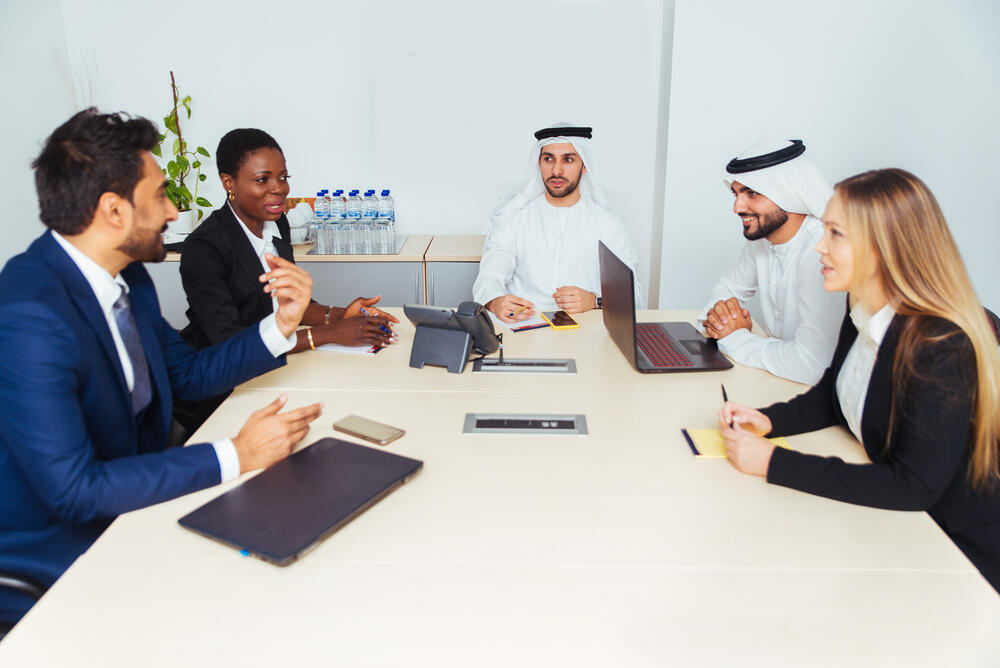 Multiracial group of business people having a meeting in a office - Teamwork in the office, business meeting in the UAE