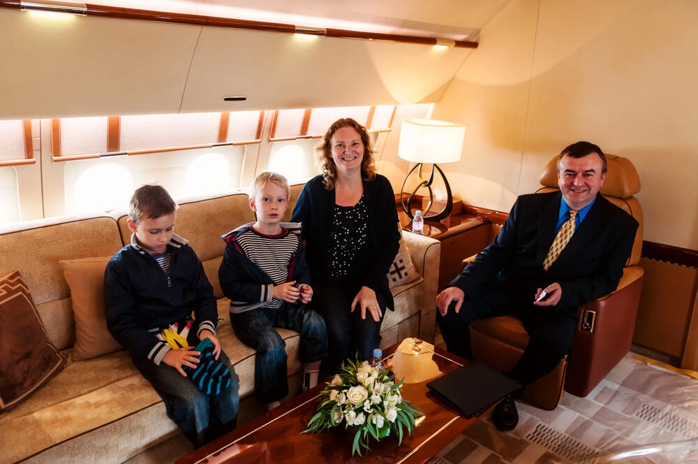 mum, dad and children enjoying private jet travel for special holiday