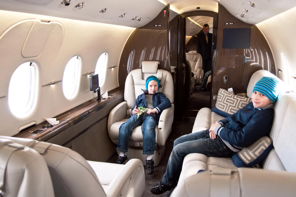 children enjoying extra leg room on private jet